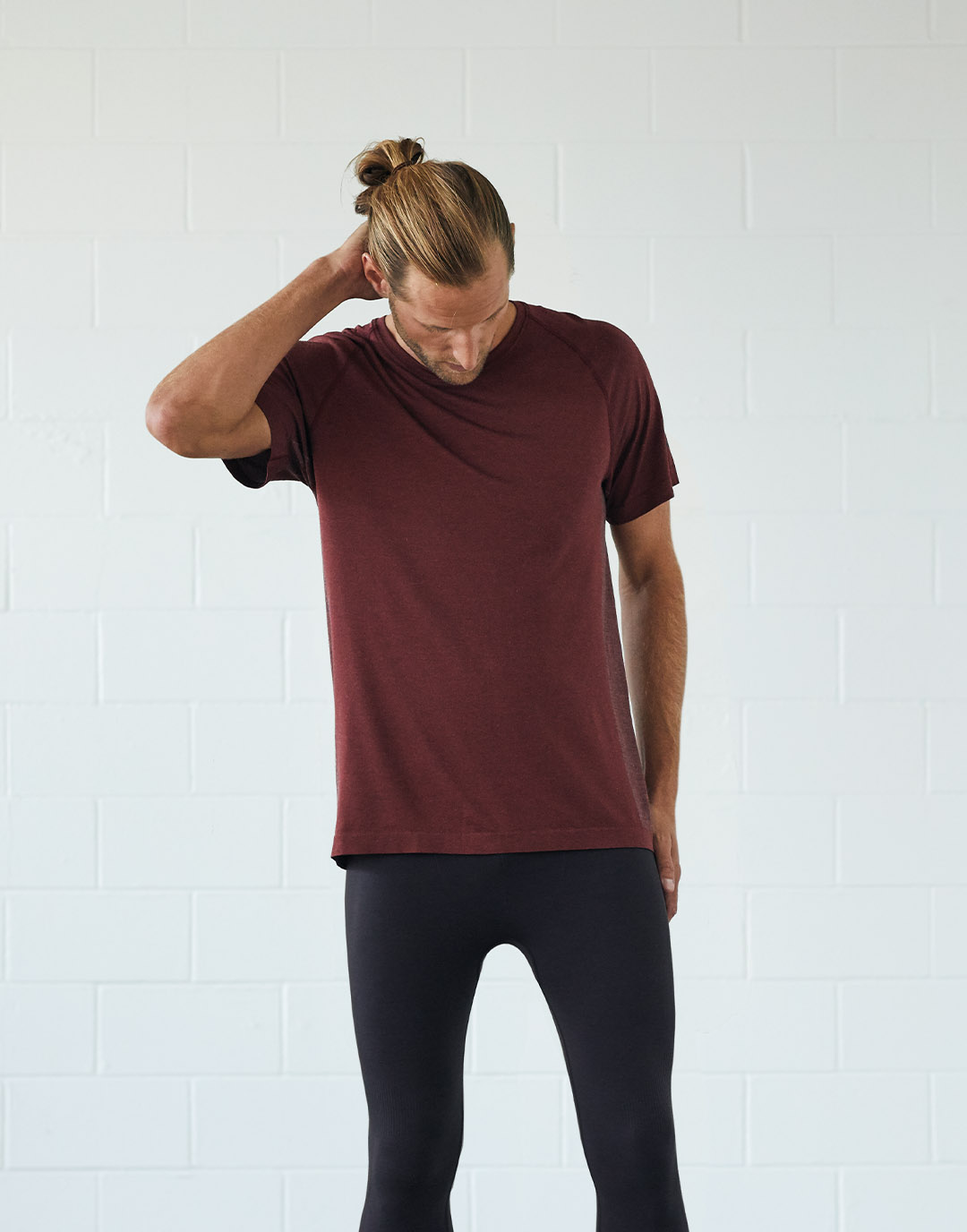 Man in red t-shirt and black leggings.